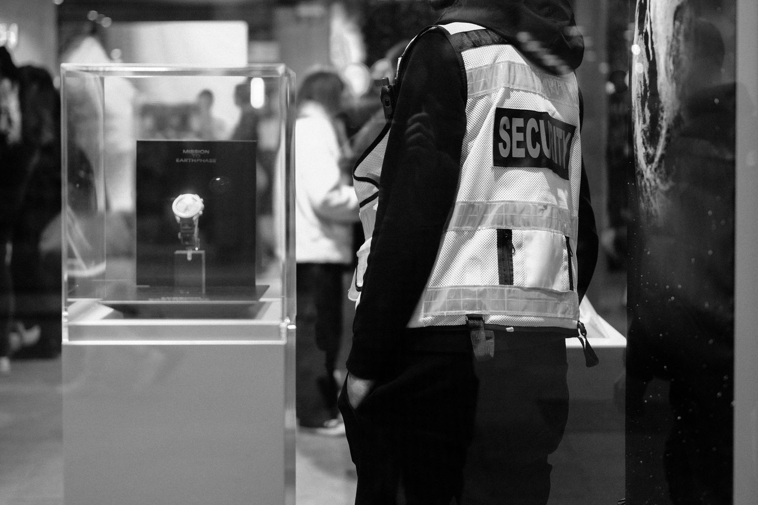 Security guard in a luxury Dublin store at night, showcasing urban security and retail ambiance.